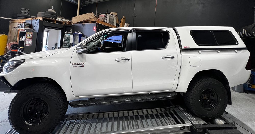 White Pickup Truck Inside a Garage for Servicing